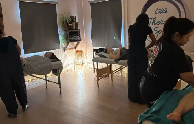 Massage therapists practicing C section recovery techniques during professional training course in Bedfordshire